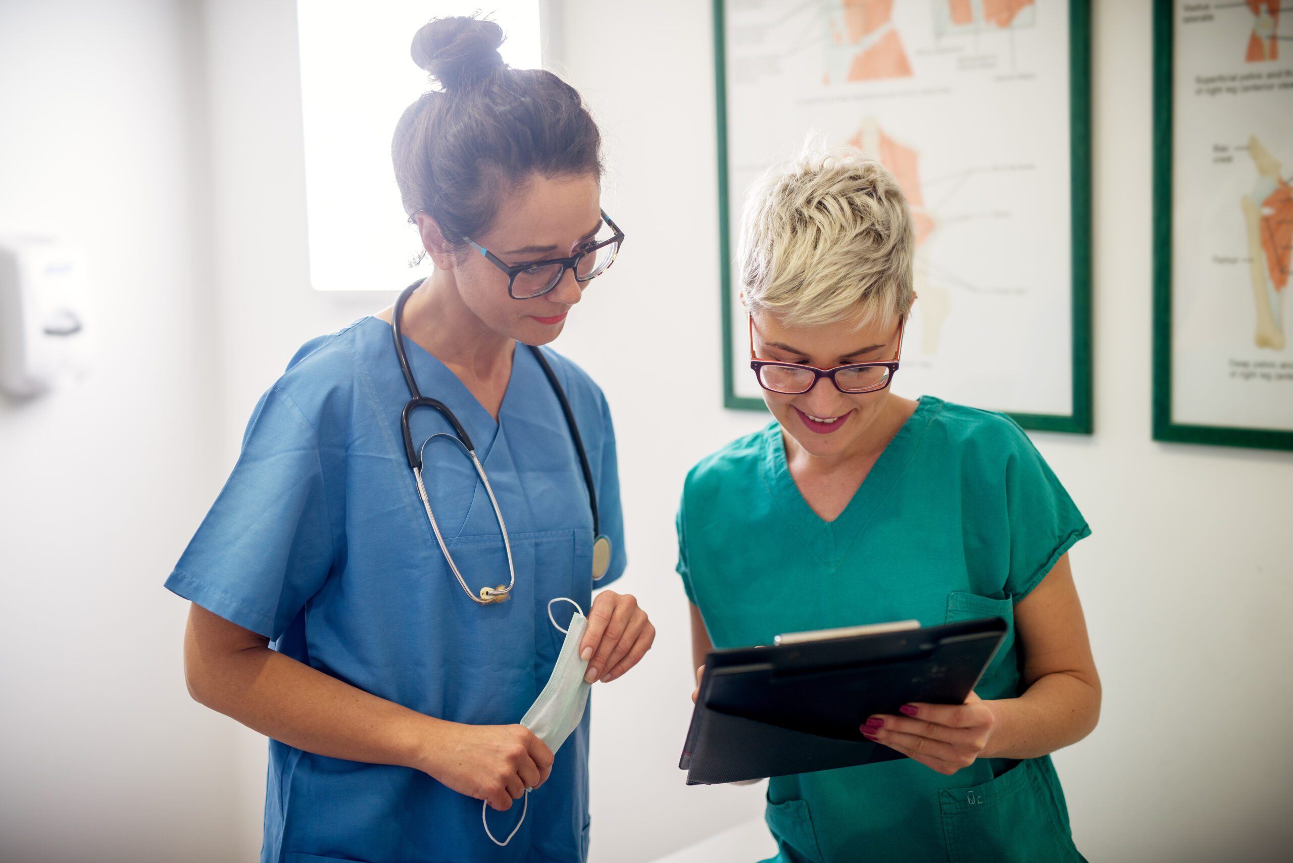 Professional nurses looking through some patients medical papers.