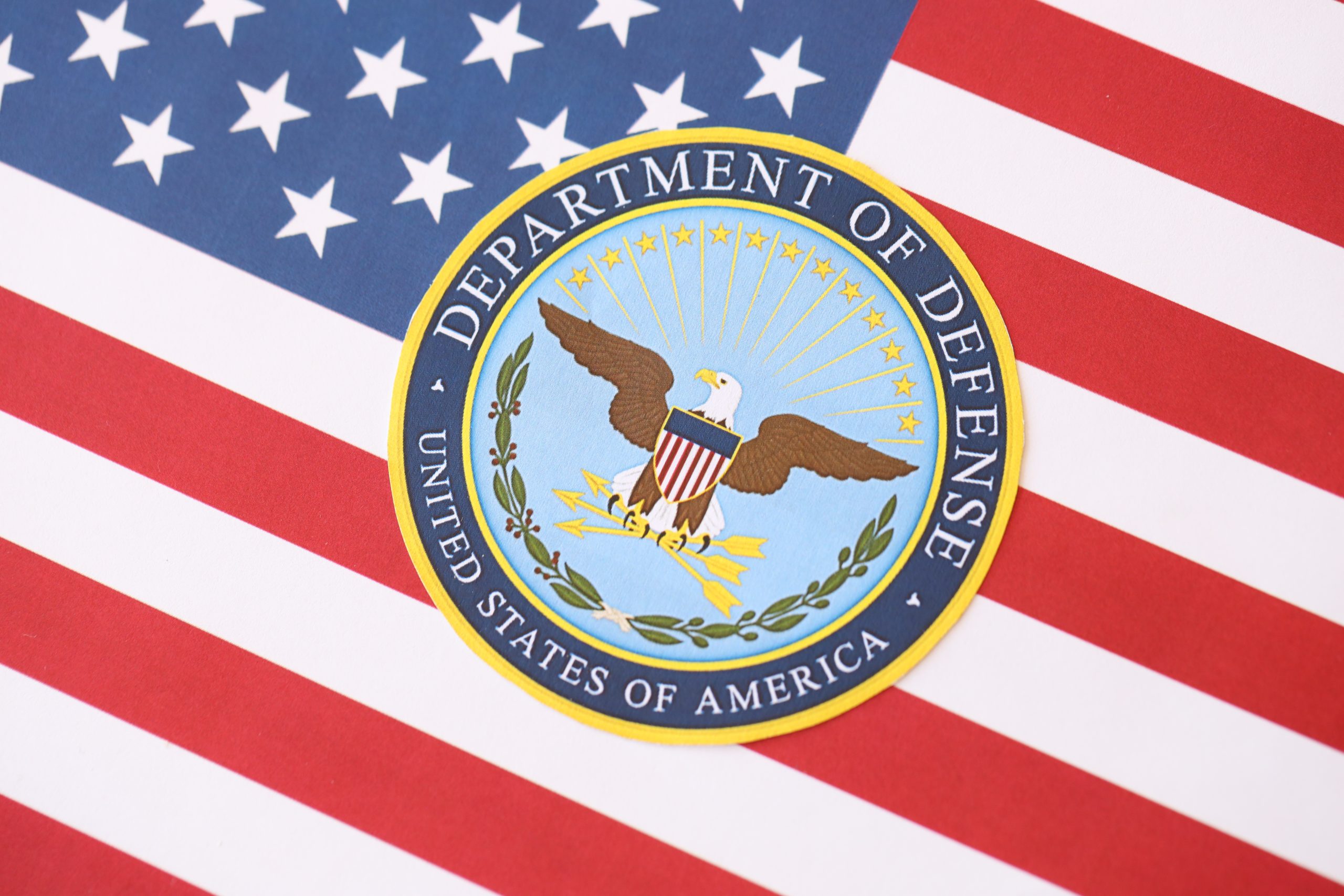 Department of Defense seal on United States of America flag close up